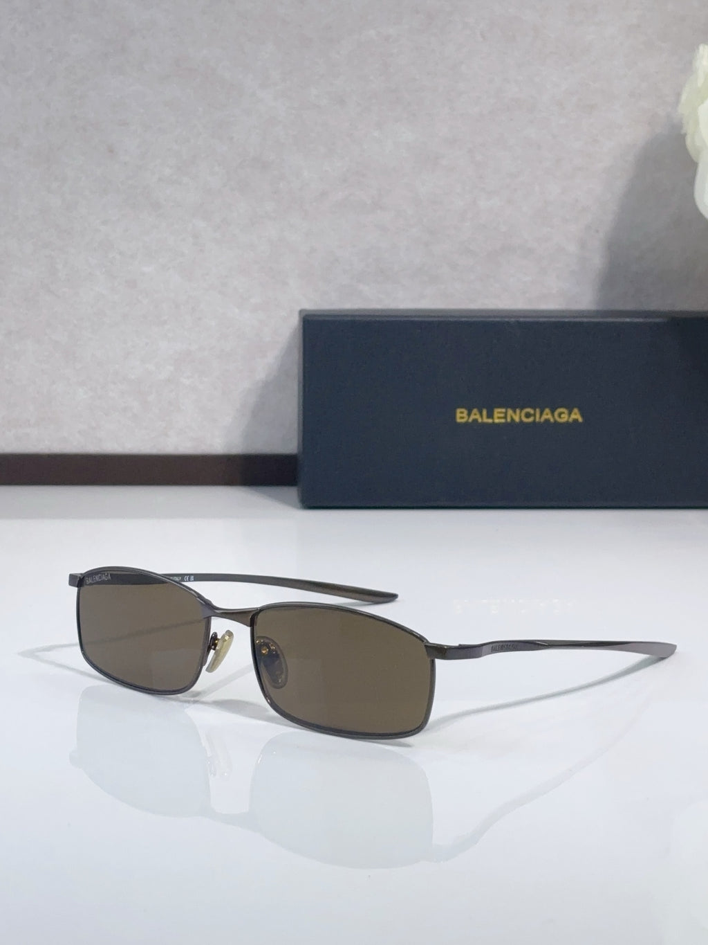 Balenciaga sunglasses with gold-tone frame and brown-tinted lenses