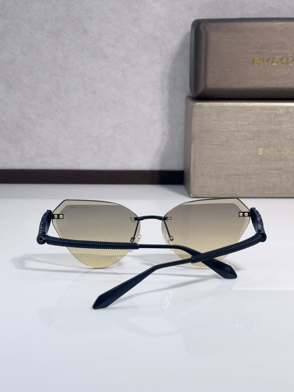 Bvlgari sunglasses with two-tone lenses and gold-tone metal frames, cat-eye style