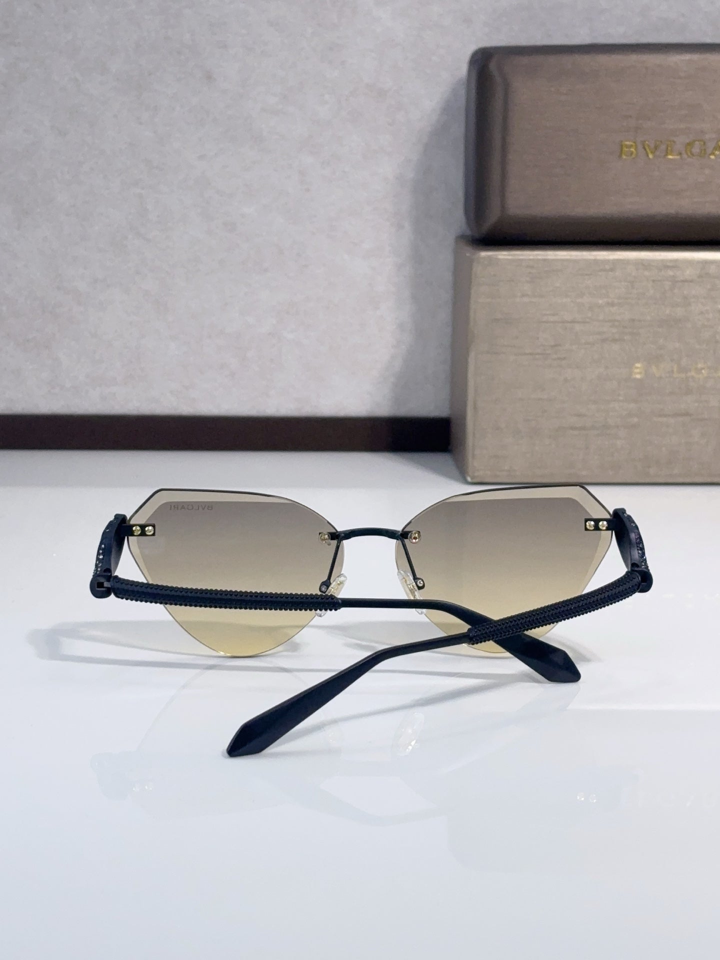 Bvlgari sunglasses with two-tone lenses and gold-tone metal frames, cat-eye style