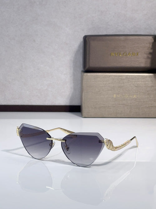 Bvlgari sunglasses with gold-tone frames and dark blue gradient lenses, cat-eye style