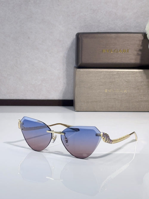 Bvlgari sunglasses with gold-tone frames and light blue gradient lenses, cat-eye style