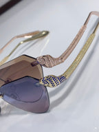 Bvlgari sunglasses with rhinestone temples and blue/purple gradient lenses, cat-eye style
