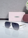 MiuMiu sunglasses with dark blue lenses and gold-tone metal frame, pointed cat-eye shape