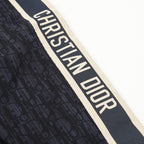 Christian Dior logo stripe on navy jogger pants with textured fabric