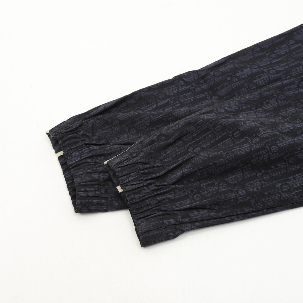 Navy jogger pants cuffs with gathered hem and textured fabric