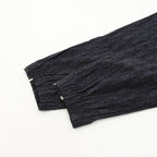Navy jogger pants cuffs with gathered hem and textured fabric