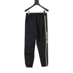 Navy jogger pants with elastic waist and side stripe with Christian Dior text