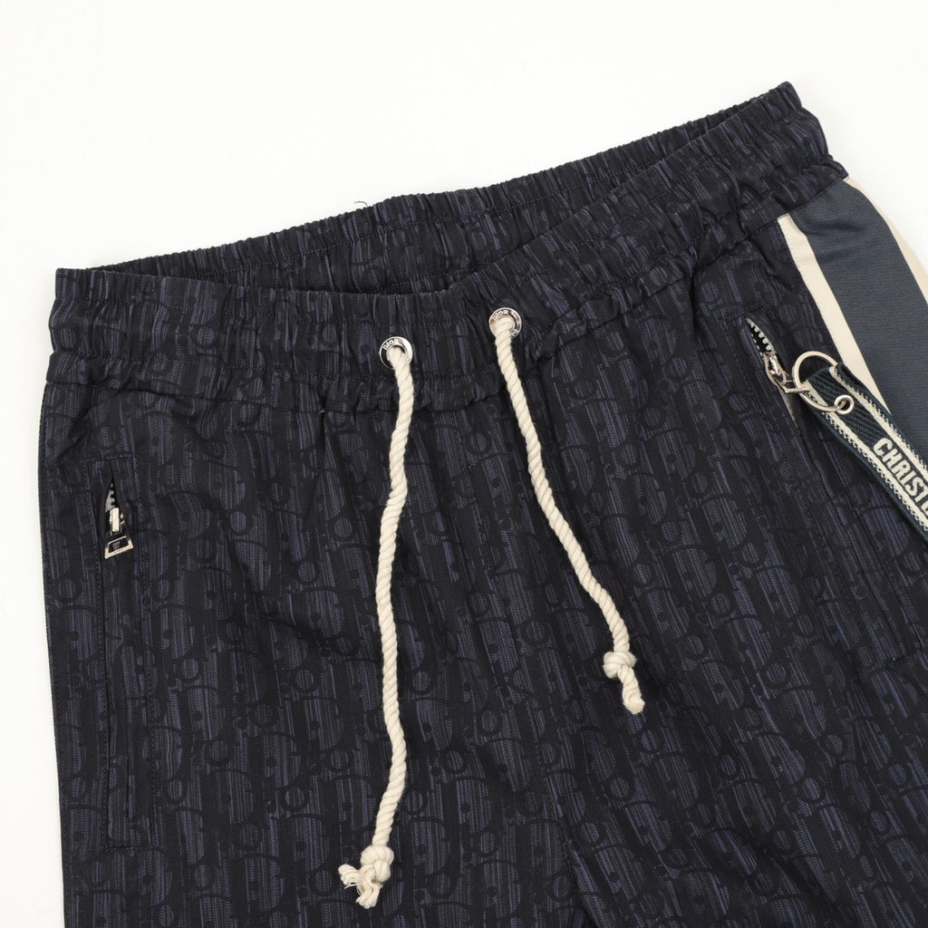 Navy printed jogger pants, elastic waist, white drawstring cords