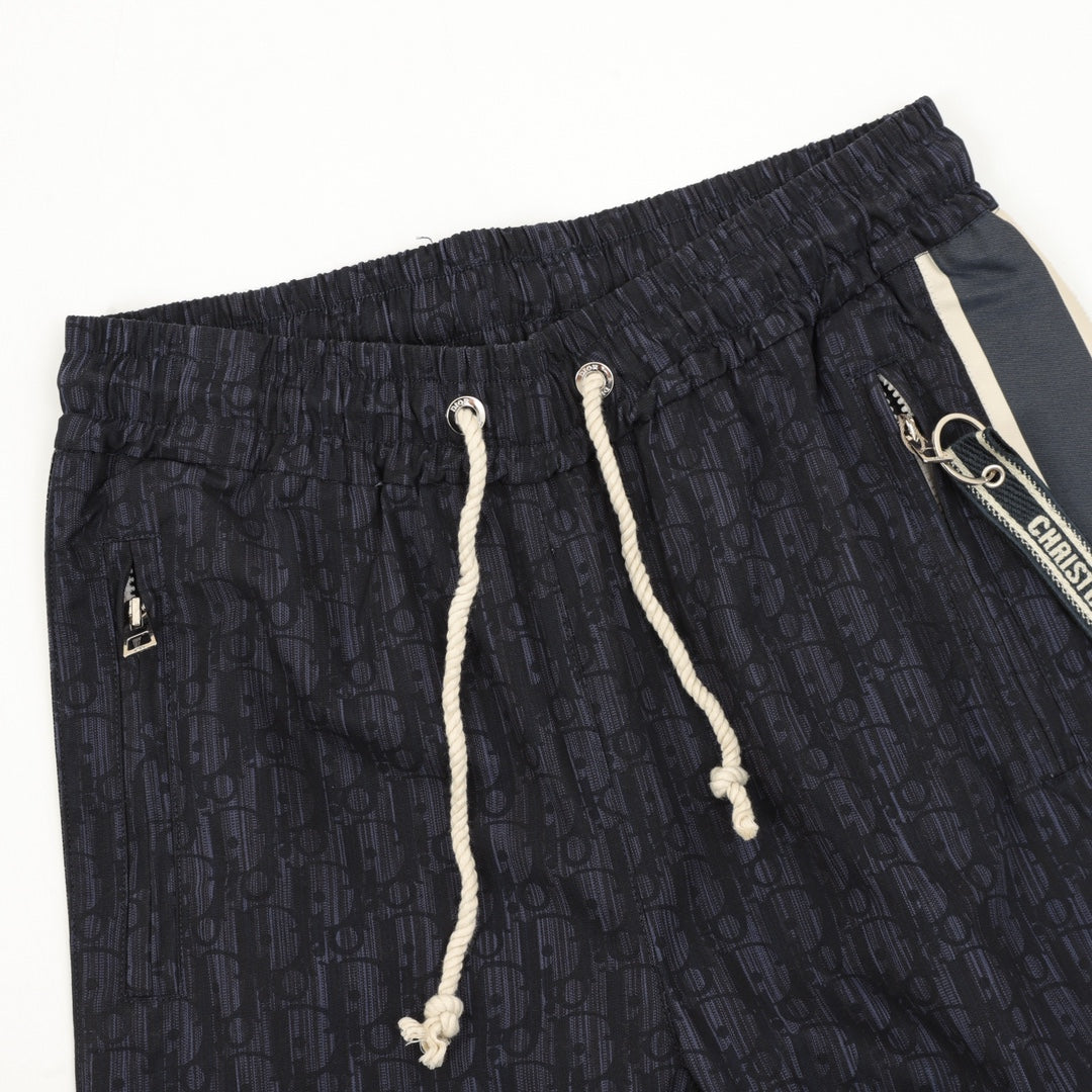 Navy printed jogger pants, elastic waist, white drawstring cords