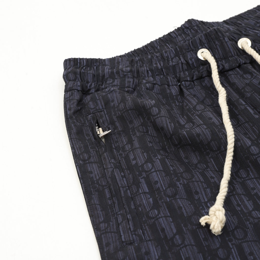 Navy printed jogger pants, elastic waist, white drawstring cords