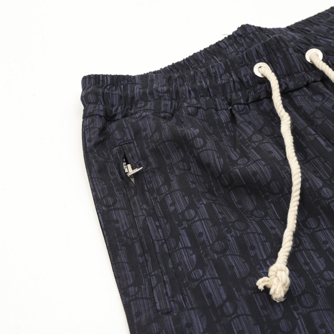 Navy printed jogger pants, elastic waist, white drawstring cords