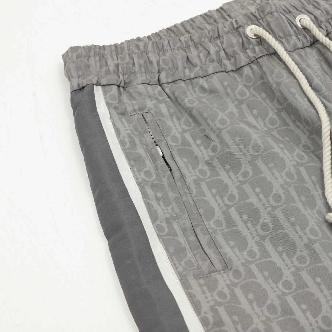 Grey Dior logo track pants with front seams and zip pocket detail