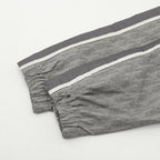 Dior pants with dark gray drape, elastic cuffs, and allover monogram pattern