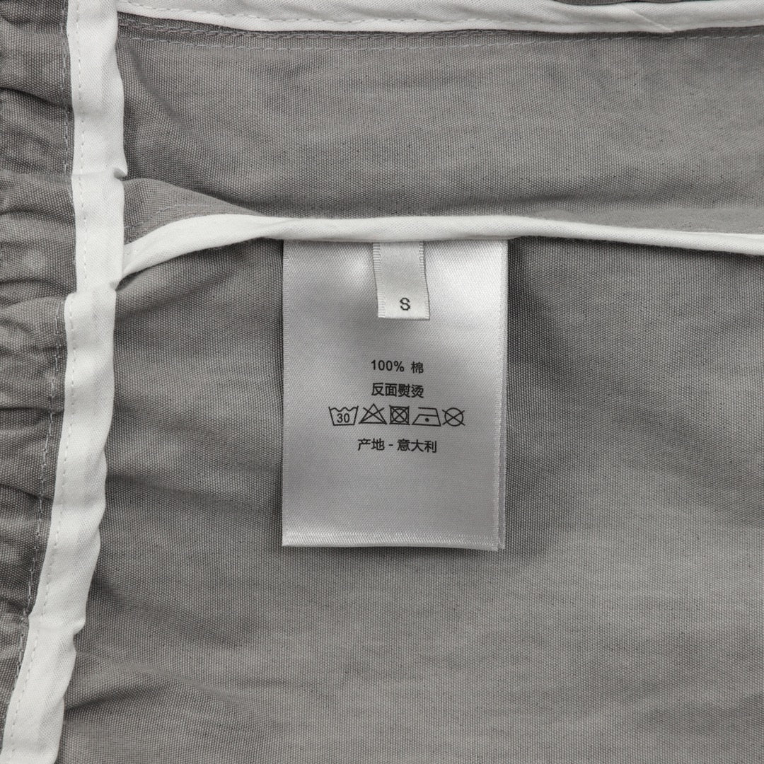 Dior pants inside size and care label on light gray fabric tag