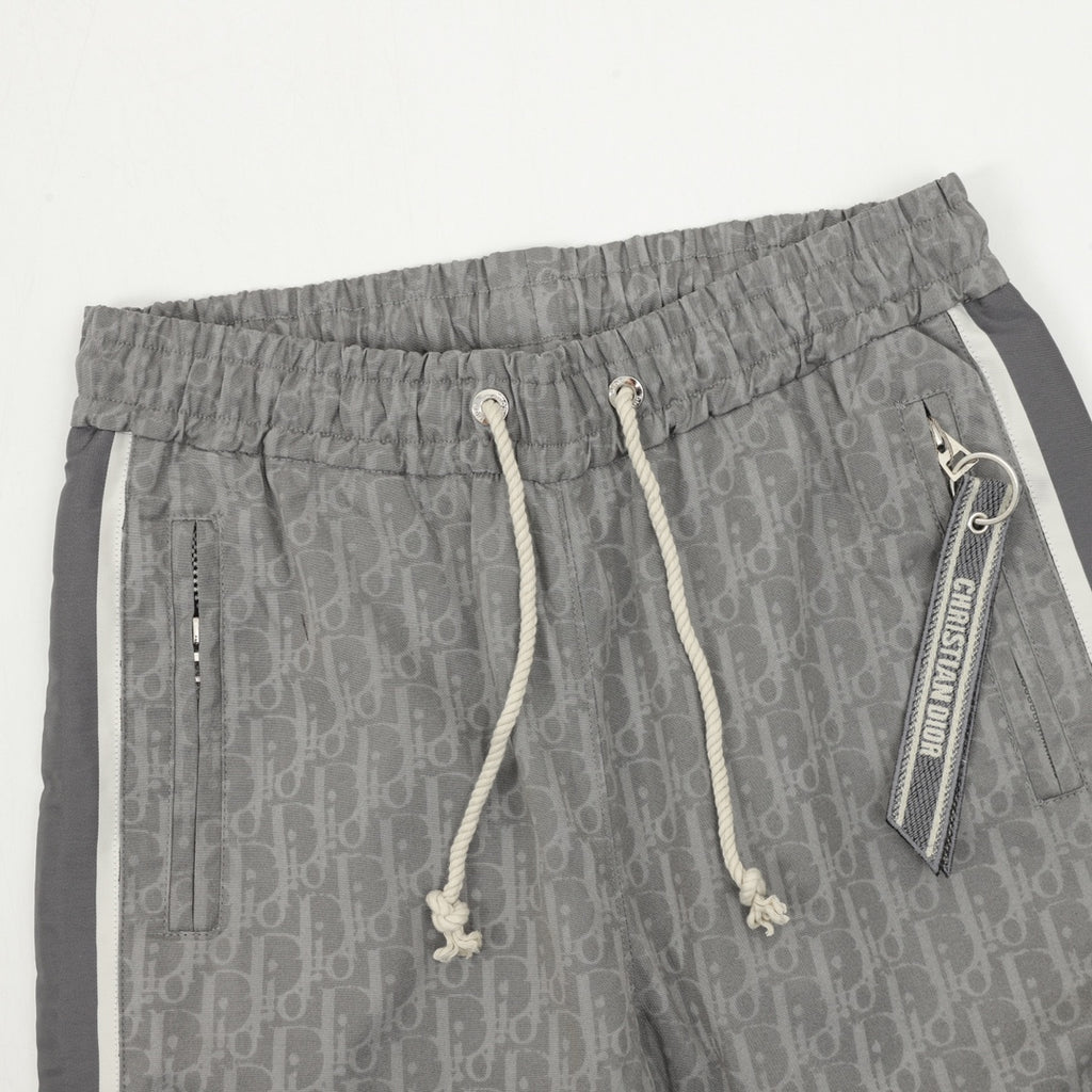 Grey Dior logo pants with drawstring waistband and decorative eyelet pull ties