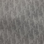 Close-up of grey Dior monogram fabric pattern on pants