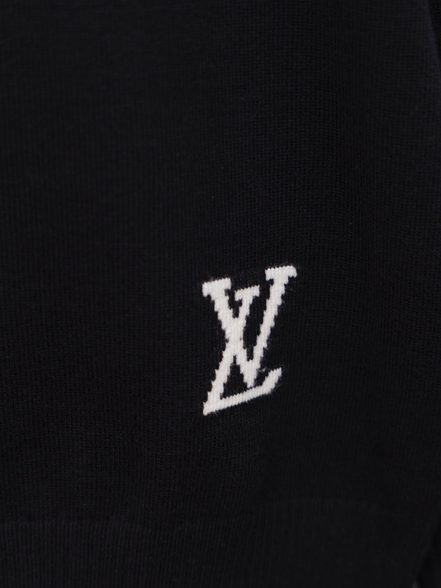 Black sweater chest logo patch with white “LV” motif