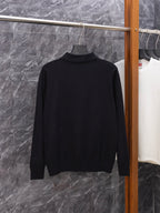 Black long-sleeve sweater with ribbed turtleneck-style collar, buttonless back view