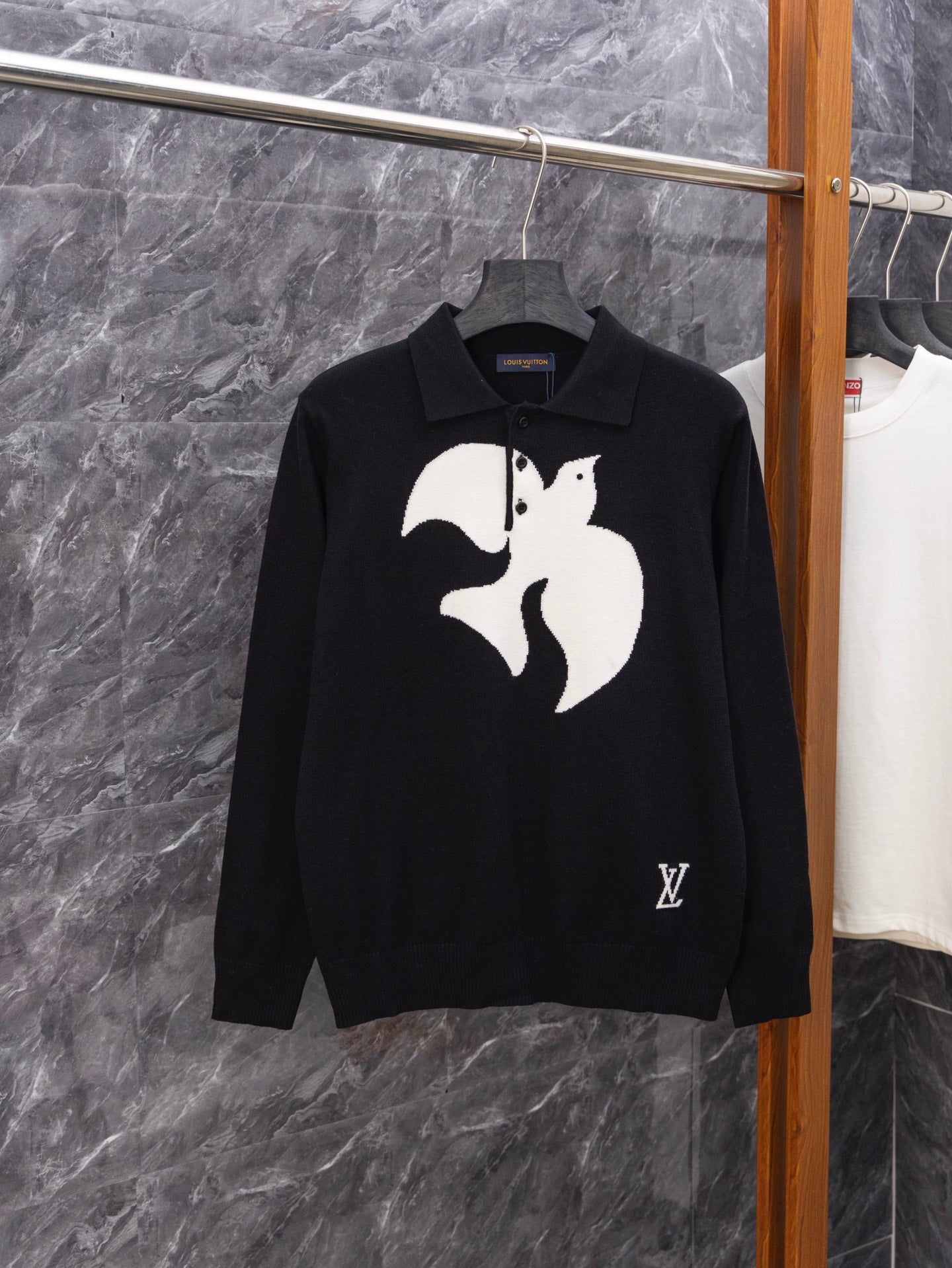 Black long-sleeve sweater with white graphic print and ribbed polo collar