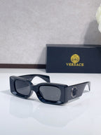 Versace cat-eye sunglasses, dark frame with dark lenses and logo detail on temple