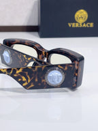 Versace cat-eye sunglasses, tortoiseshell frame with gold-pattern temple and medallion