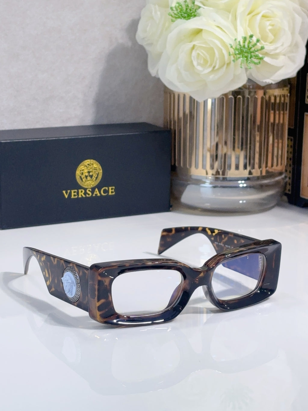 Versace cat-eye sunglasses, tortoiseshell frame with blue-tinted lenses and logo medallion
