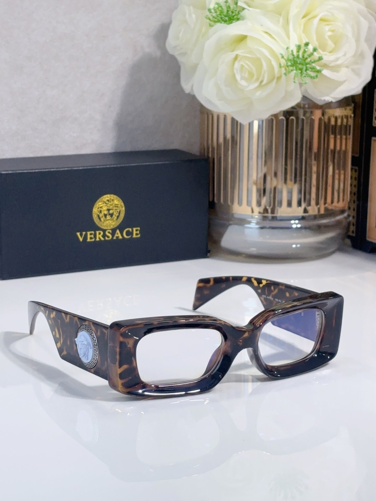 Versace cat-eye sunglasses, tortoiseshell frame with blue-tinted lenses and logo medallion