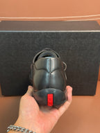 Prada leather lace-up shoes in dark blue, close view of heel with red label
