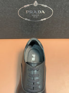 Prada lace-up leather shoes in dark blue, close view of toe and lace panel