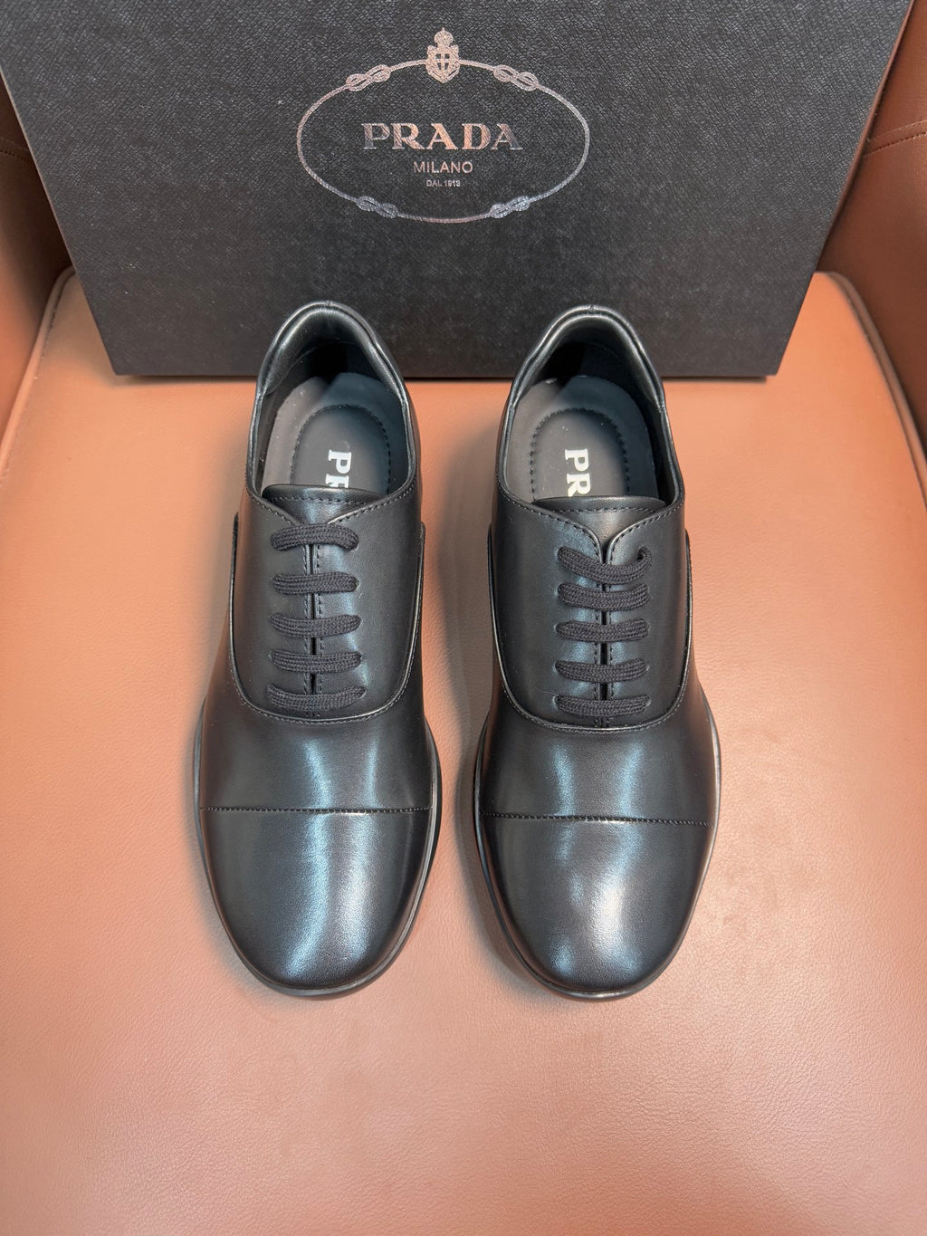 Prada lace-up leather shoes in dark blue, black laces, PRADA logo on tongue