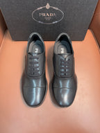 Prada lace-up leather shoes in dark blue, black laces, PRADA logo on tongue