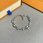 Silver charm bracelet with central LV pendant and star and clover accents