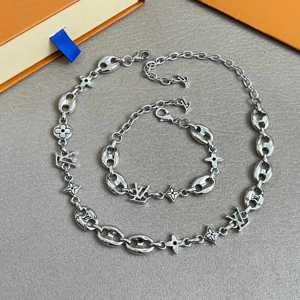 Silver-tone charm bracelet with clover and star links and lobster clasp