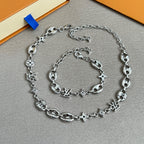 Silver-tone charm bracelet with clover and star links and lobster clasp