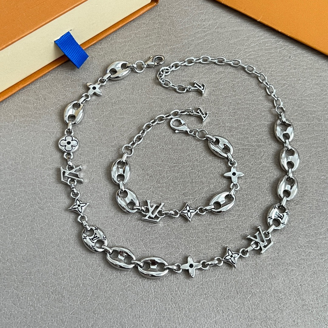 Silver-tone charm bracelet with clover and star links and lobster clasp