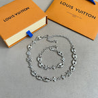 Silver charm bracelet with oval and star/clover charms on a link chain