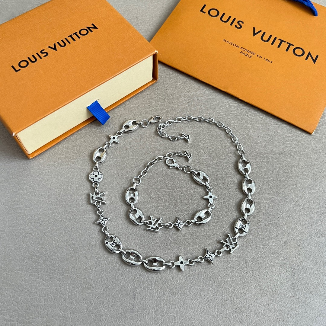 Silver charm bracelet with oval and star/clover charms on a link chain