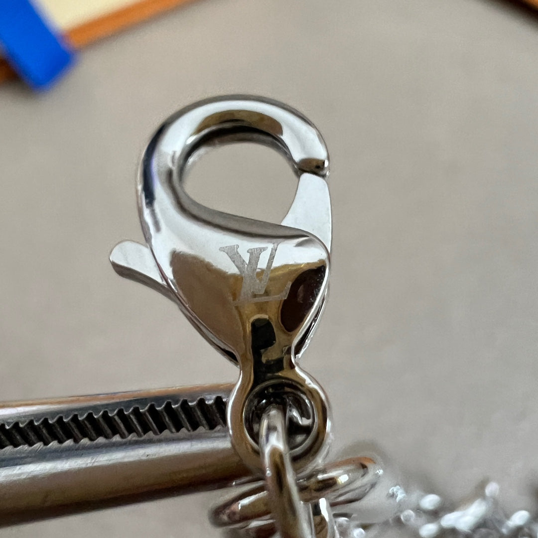 Silver lobster clasp with LV engraving on charm bracelet