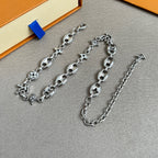 Silver-tone charm bracelet with clover, star and flower motifs, adjustable chain
