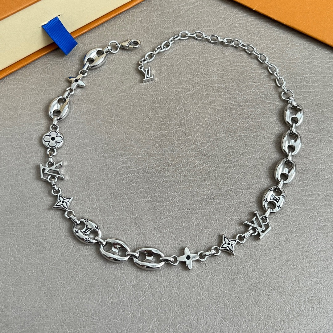 Silver-tone charm bracelet with clover and star charms and extender chain