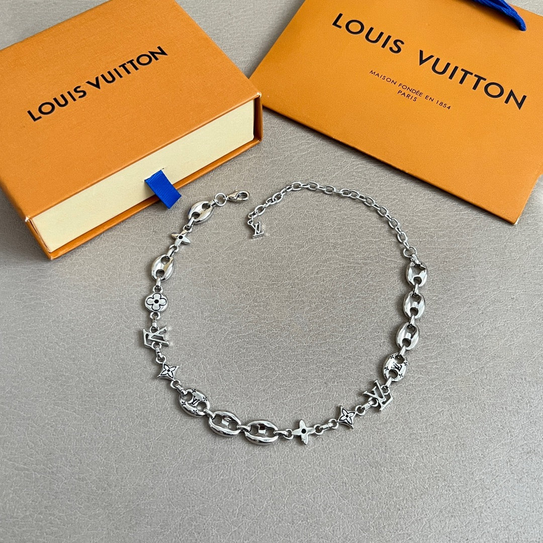 Silver-tone chain bracelet with clover and star charms, adjustable clasp
