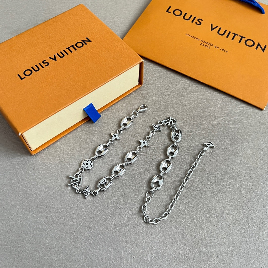 Silver-tone charm bracelets with clover and star motifs, multiple pieces