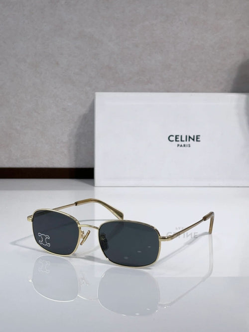 Oval sunglasses with gold-tone frame and dark blue lenses, clear bridge and temples