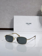 Oval sunglasses with gold-tone frame and dark blue lenses, logo on temples