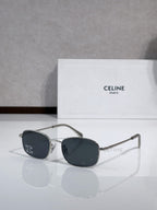 Oval sunglasses with silver-tone frame and dark lenses, curved temple with logo