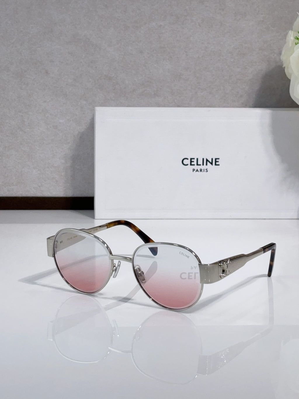 Round sunglasses with silver frame, pink-tinted lenses, tortoise-look accent arms