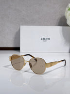 Round sunglasses with gold-tone frame, amber-tinted lenses, tortoise-look temple accents