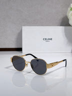 Round sunglasses with gold-tone frame, dark lenses, black accents on the temples
