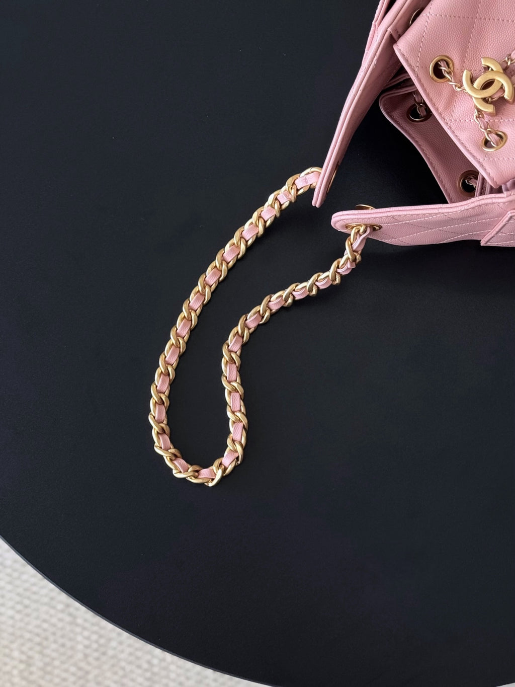 Pink Chanel handbag with gold braided chain strap and top edge hardware