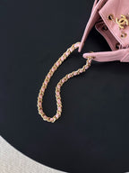Pink Chanel handbag with gold braided chain strap and top edge hardware